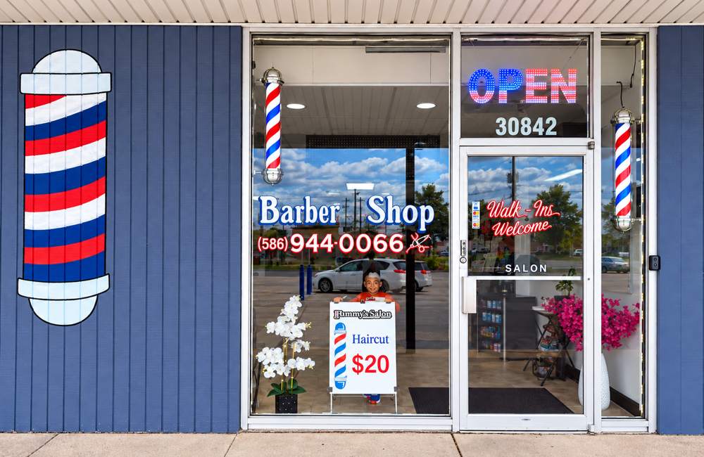Ramy's storefront at 30842 Schoenherr Road: blue front, painted barber pole, lit OPEN sign and Walk-Ins Welcome on the door